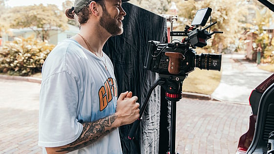 Dokumentärfilmare i vit t-shirt skapar film för att engagera unga människor